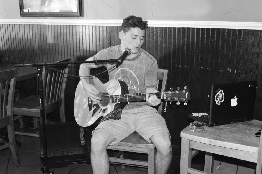 Junior Quinn Cassell plays guitar and sings at Potbelly Sandwich Shop in Highland Park. Cassell began learning how to play the guitar at age 9. 