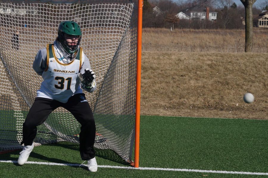 Goalie Cade Bauer practices saves without a stick at Techny Prairie Park and Fields. Bauer said the implementation of VR technology into the lacrosse program would help improve his training. Photo by Dylan Buckner