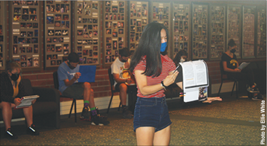Junior Claire Chang reads her lines during a rehearsal in the CPA lobby. “The Laramie Project” is scheduled to be broadcast at 7 p.m. on Oct. 22, Oct. 23 and Oct. 24. Photo by Ellie White