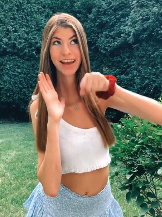 Senior Chloe Pasman dances for a TikTok in her backyard. Pasman has used TikTok to share her experience with SEPN1 muscular dystrophy. Photo by Alexa Stolyarov