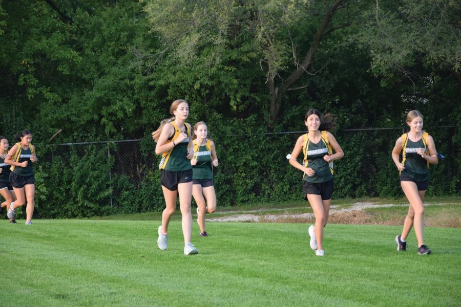 JV cross country runners round a turn of their 3-mile race at Glenbrook North on Sept. 15. Cross country teams have implemented new safety protocols to prevent the spread of COVID-19. Photo by Natalie Sandlow