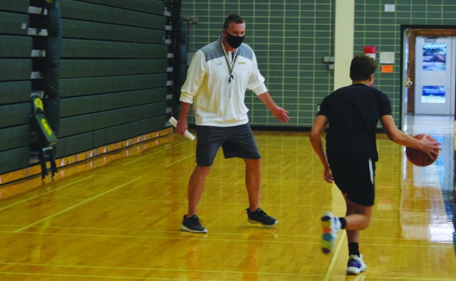 Quin Hayes, head boys varsity basketball coach (left), works with players at a contact day on Nov. 4. Hayes was hired in April after six seasons at Saint Viator High School. Photo by Natalie Sandlow