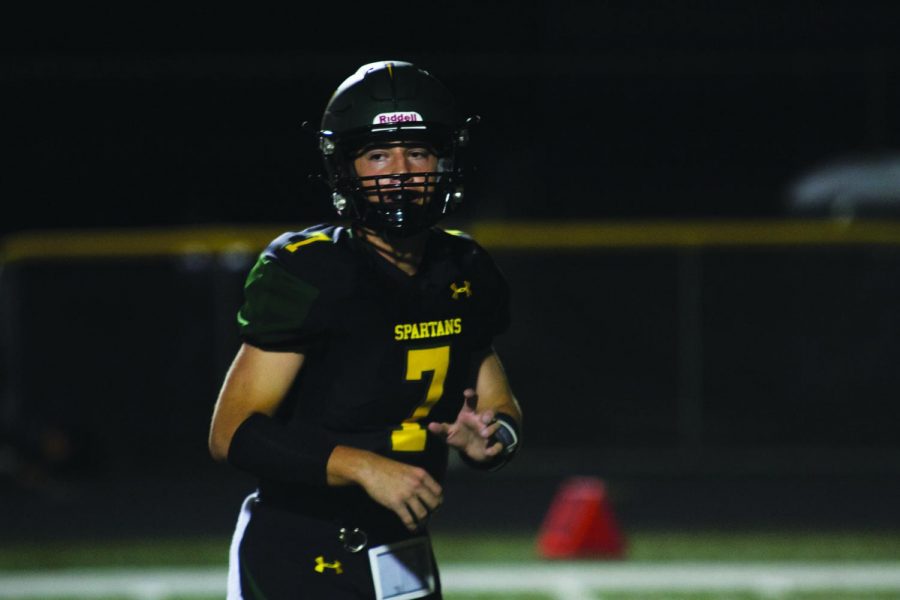 Dylan Buckner plays during the 2019 Homecoming football game against Glenbrook South. Buckner was the starting varsity quarterback during his sophomore and junior seasons. Photo courtesy of Stuart Rodgers