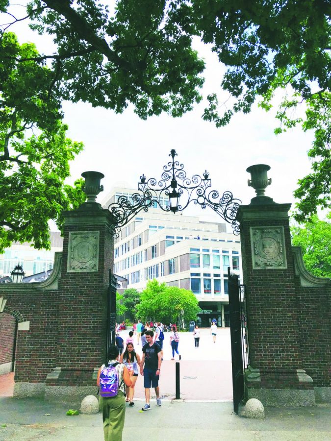 Prior to the COVID-19 pandemic, visitors and students walk around Harvard Universitys campus. Harvard used SAT Subject Tests, which will be discontinued in June 2021, as a part of their admissions process. Photo by Theresa Lee