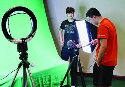 For their upcoming film, Outerlands, seniors Alexander Kardasis (left) and Wyatt Wolf film their robot named “K.I.T.” They began filming Outerlands after finishing their short film “Incompatible,” which won first place in the IHSA Drama State Series Film Festival. Photo by Alex Garibashvily
