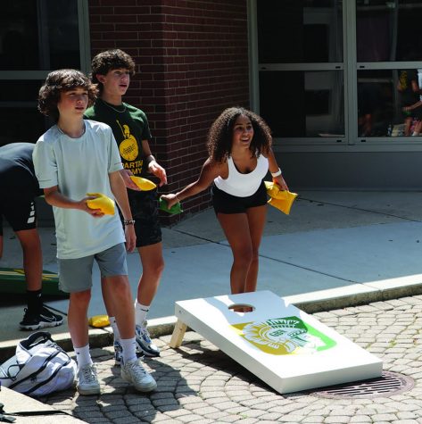 During lunch, students play corn hole outside in the student mall. Students should take advantage of opportunities to engage in activities and events to elevate school mindset. Photo by Alex Garibashvily