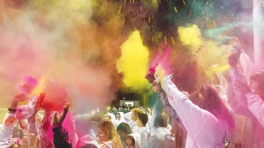 Students+throw+colorful+powder+in+the+stands+of+the+football+stadium%2C+turning+the+white-out+student+section+into+a+blend+of+colors+at+the+kickoff+of+the+GBN+v.+GBS+football+game+on+Oct+15.+Fundraising+events+throughout+the+week+leading+up+to+and+at+the+game+went+towards+Hurricane+Ida+relief.+Photo+by+Alicia+Amsel
