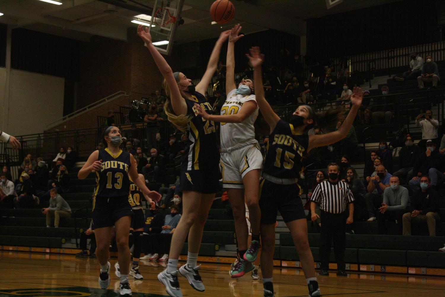 After driving to the basket, freshman Alexis Myers shoots a contested layup in a game against Glenbrook South on Nov. 30. This was the girls varsity basketball teams first loss of the season as they fell to GBS in overtime 49-46. Photo by Brady Rassin