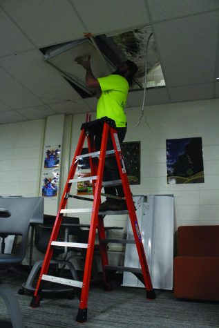 As a part of the “Total Classroom” initiative, maintenance employee Wesley Garbutt replaces an old light with a new LED light. All newly installed lights are planned to have a dimming feature to adjust lighting. Photo by Jiya Sheth.