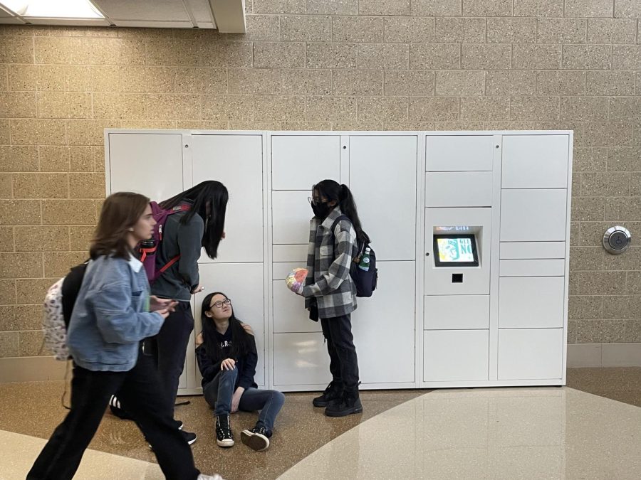 Students+chat+near+the+newly+installed+electronic+lockers+by+the+Visitor+Center.+The+electronic+lockers+are+going+to+replace+the+cart+holding+items+inside+the+Visitor+Center+to+be+a+more+secure+and+convenient+system+for+students+retrieving+their+items.+Photo+by+Noah+Kaufman