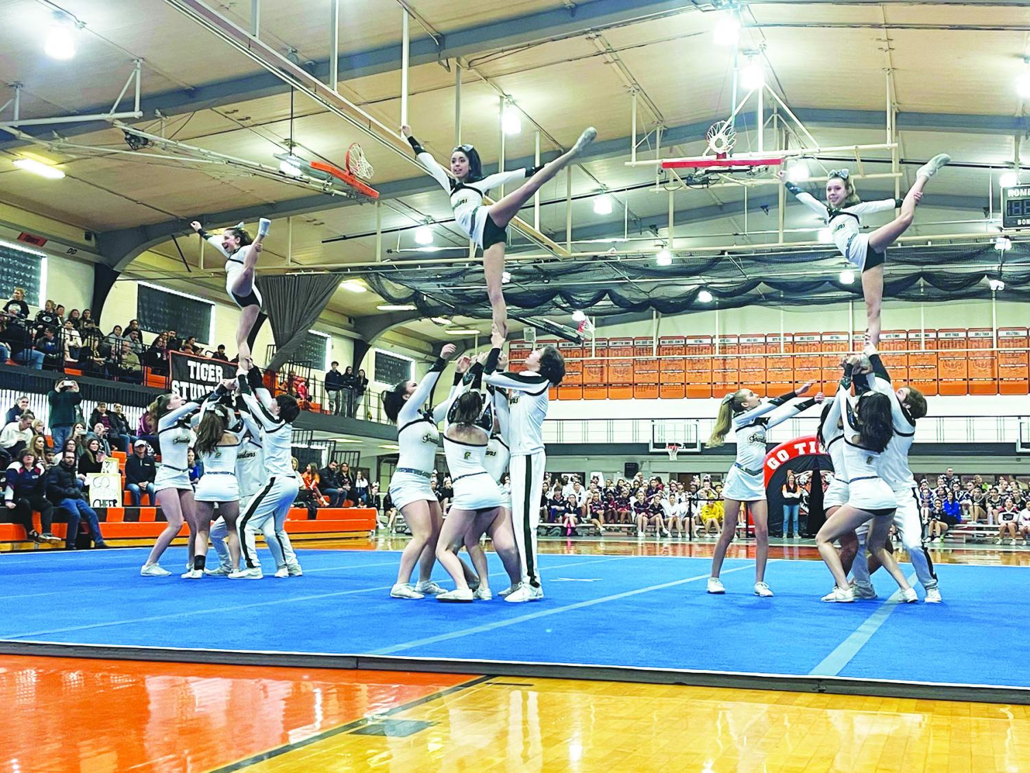 Cheer squad implements harder stunts – Torch