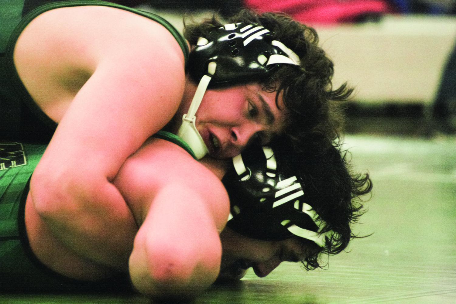 Senior Owen Washlow rides his Lane Tech opponent in a meet against Lane Tech and Elmwood Park on Jan. 19. Washlow won the match after pinning his opponent in the second round on the team’s senior night. Photo by Jada Glazebrook