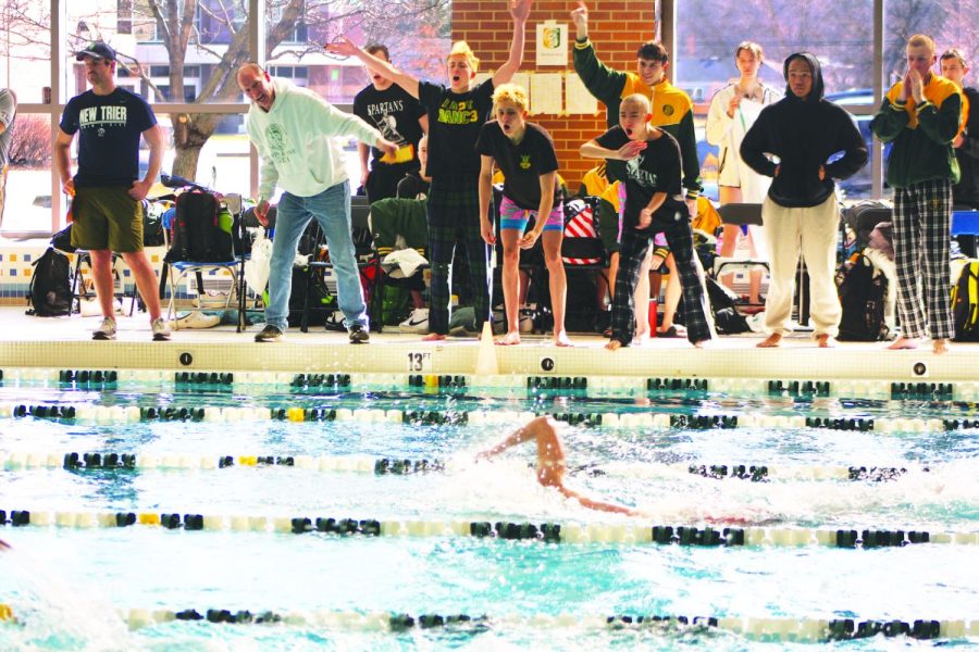 During the conference meet at Glenbrook South on Feb. 11, the swim and dive team cheers on their teammate. The team placed second, and several members of the team achieved personal best times. Photo by Karsten Konstant