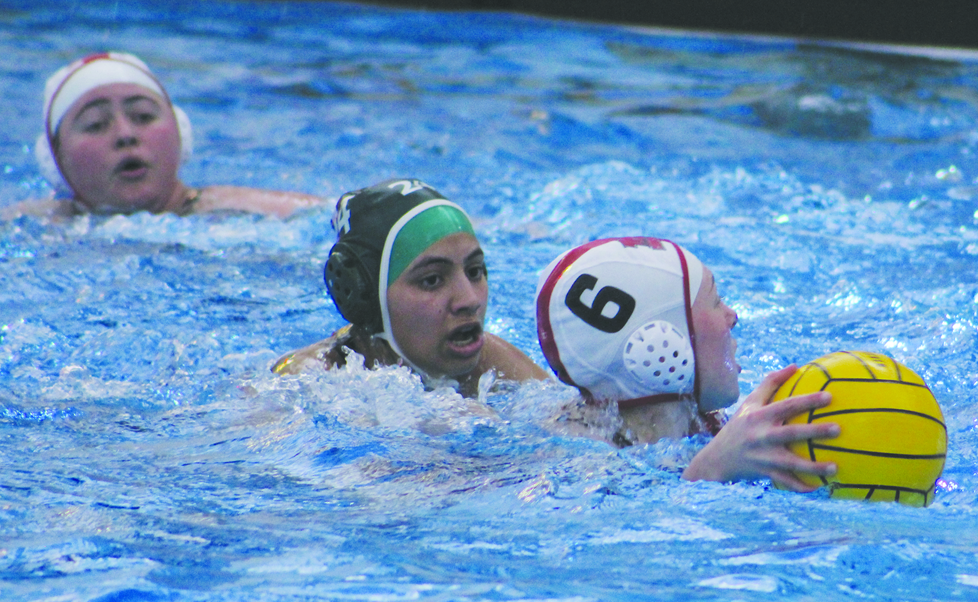 Junior Anika Moghe (middle) attempts to steal the ball from her Palatine opponent at a game on March 21. The team won 16-1. Photo by Jiya Sheth