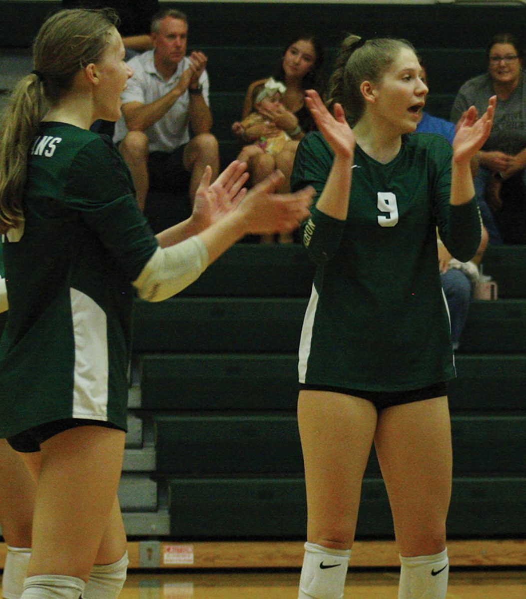Freshman Courtney Owen (left) and senior Brianna Owen celebrate together after the team wins a point in a game against Highland Park on Sept. 6. The point contributed to the 26-24 win in the second set with the match ending in a Spartan victory. Photo by Cailyn Kelsen