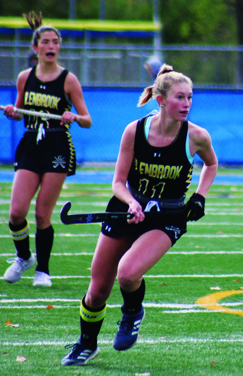 Senior Madison Beach (right) runs upfield during the state final against New Trier at Lake Forest on Oct. 28. Beach plans to continue her field hockey career at Duke University next fall. Photo by Lara White