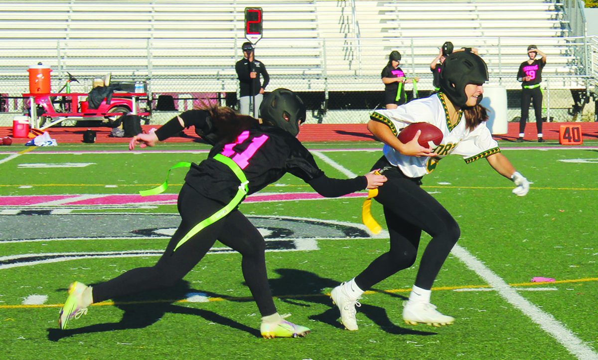 In the team’s final game of the season, junior Stefani Pecaro’s flag gets pulled as she attempts to rush the ball downfield in an away game against Deerfield on Oct. 17. Glenbrook North lost the game 16-14 in the first round of the inaugural Central Suburban League Flag Football playoffs. Photo by Faith Sharpe