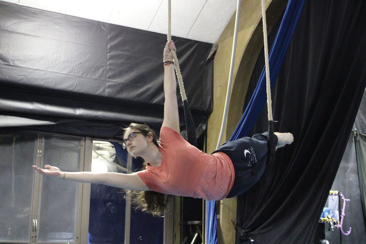 Senior Charli Fomin performs an aerial circus skill, called a Mermaid, on a trapeze before class on Dec. 7. Fomin takes circus arts and silks classes at The Actors Gymnasium in Evanston.
