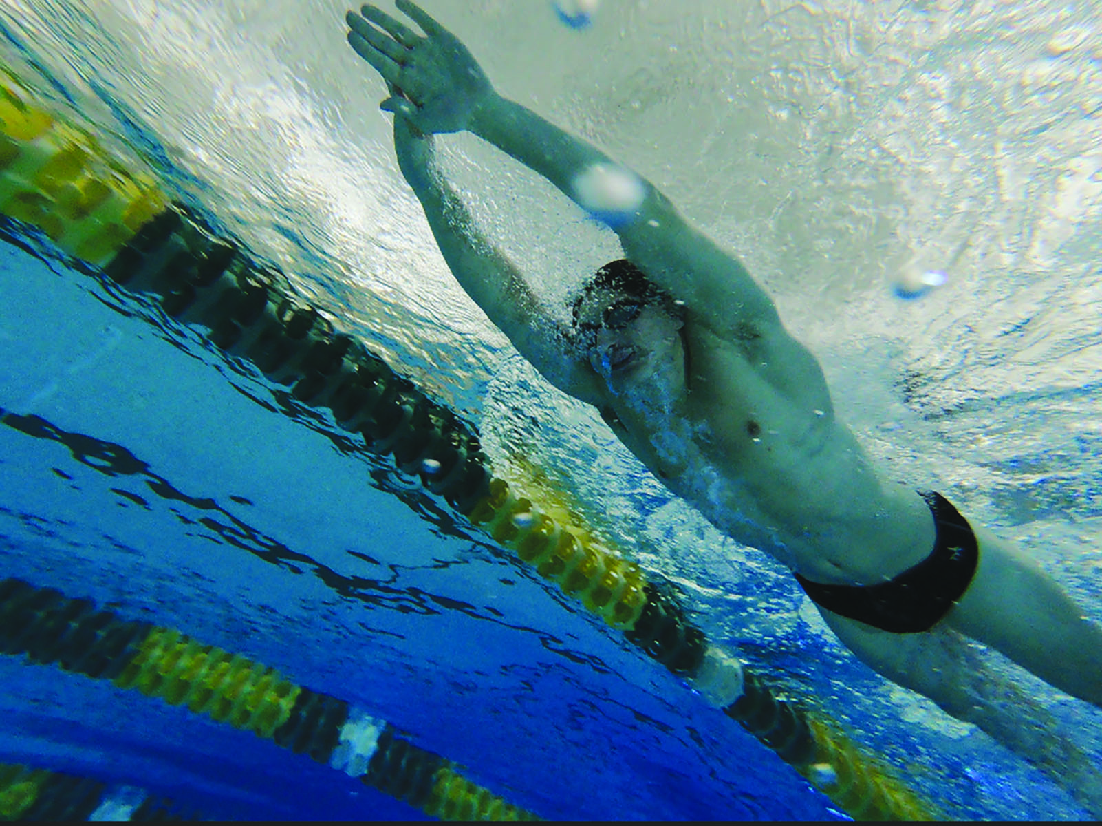 Junior Evan Gitlevich swims breaststroke at practice on Nov. 27. Gitlevich competes individually in the 100-yard breaststroke and the 100-yard butterfly during meets, but he swims every stroke during some practices. Photo by Euben Ko