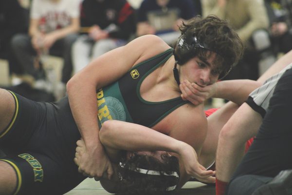Sophomore Henry Hafner, 157-lbs. division, puts his opponent in a headlock in a home meet against Maine South on Dec. 8. Hafner won his match by pinning his opponent, but the team lost the meet 46-31.