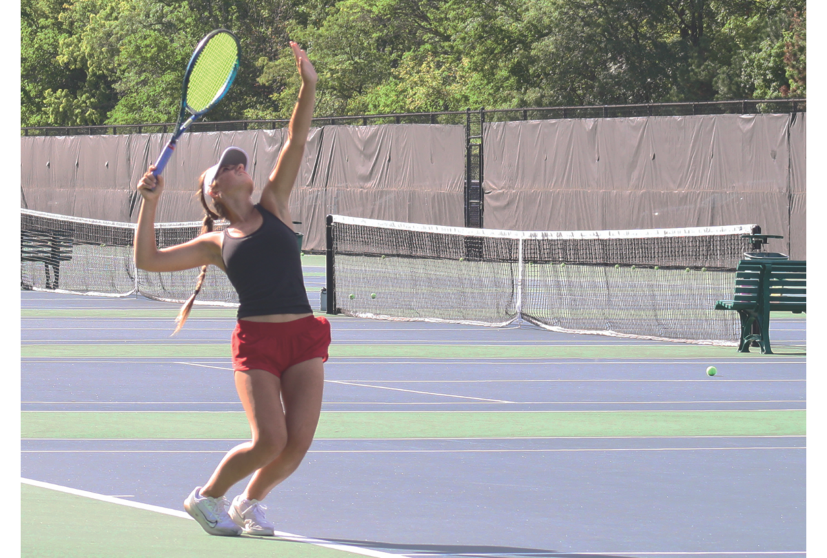Junior Klaudia Wietecha practices her serve during a varsity tennis practice. Fall sports, like tennis, will begin closer to the start of the school year with the updated calendar.