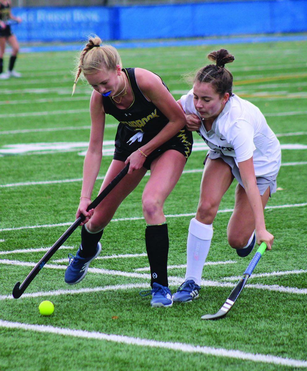 Junior Ella Beach (left) dribbles the ball during the 2023 IHSA Field Hockey State Championship. Beach spent the first semester of the 2024-2025 school year in the Netherlands playing field hockey.