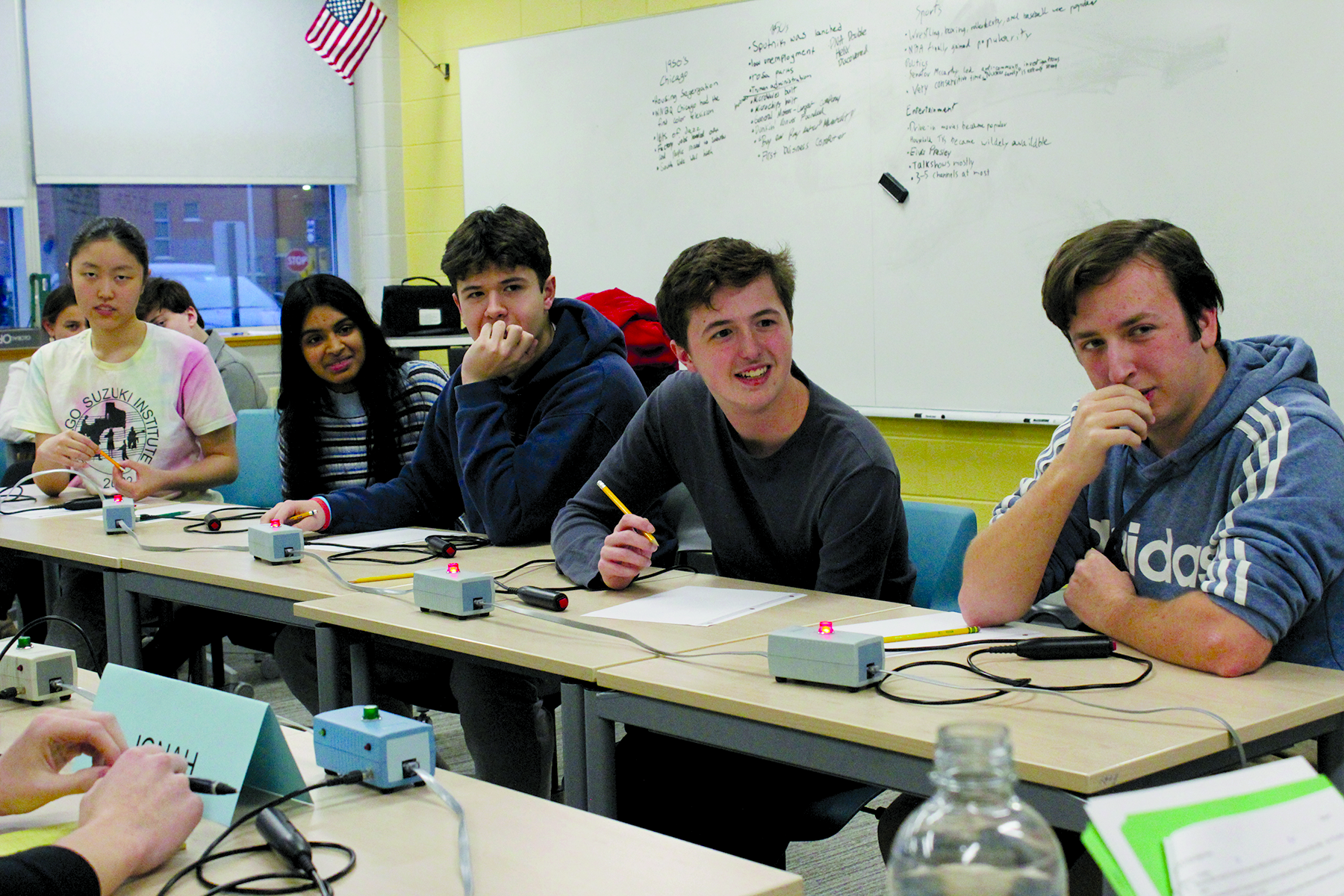 Seniors Atchaya Muthupalaniappan (left), Martín Sarmiento (center) and junior Jonathan Byrne listen to a question during a Scholastic Bowl match against Vernon Hills on Jan. 30. The team won by 30 points to bring their season record to 7-2.