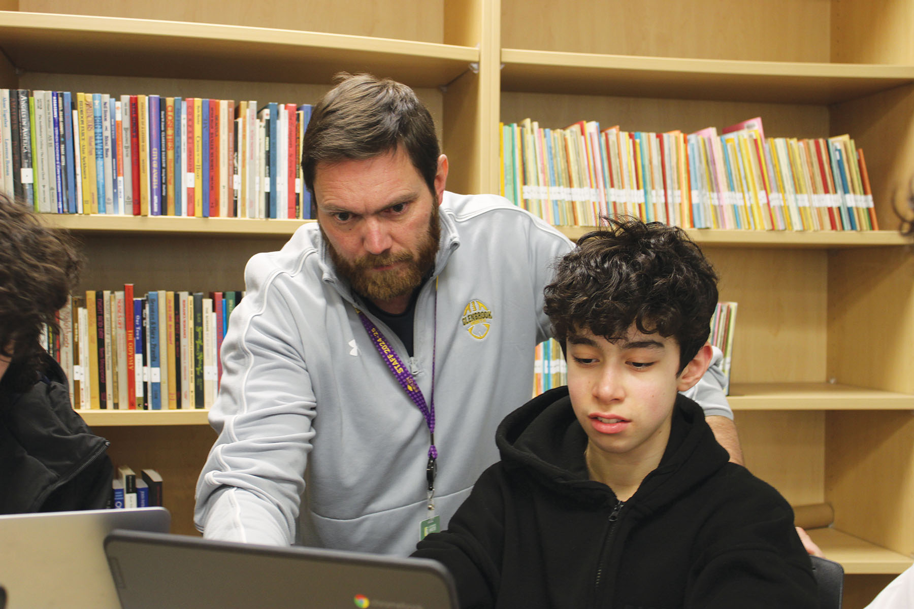 Investonomics sponsor Matthew Laufenberg helps freshman Aiden Barder invest on MarketWatch, a stock market simulation game on March 12. The club began meeting for the first time this school year.