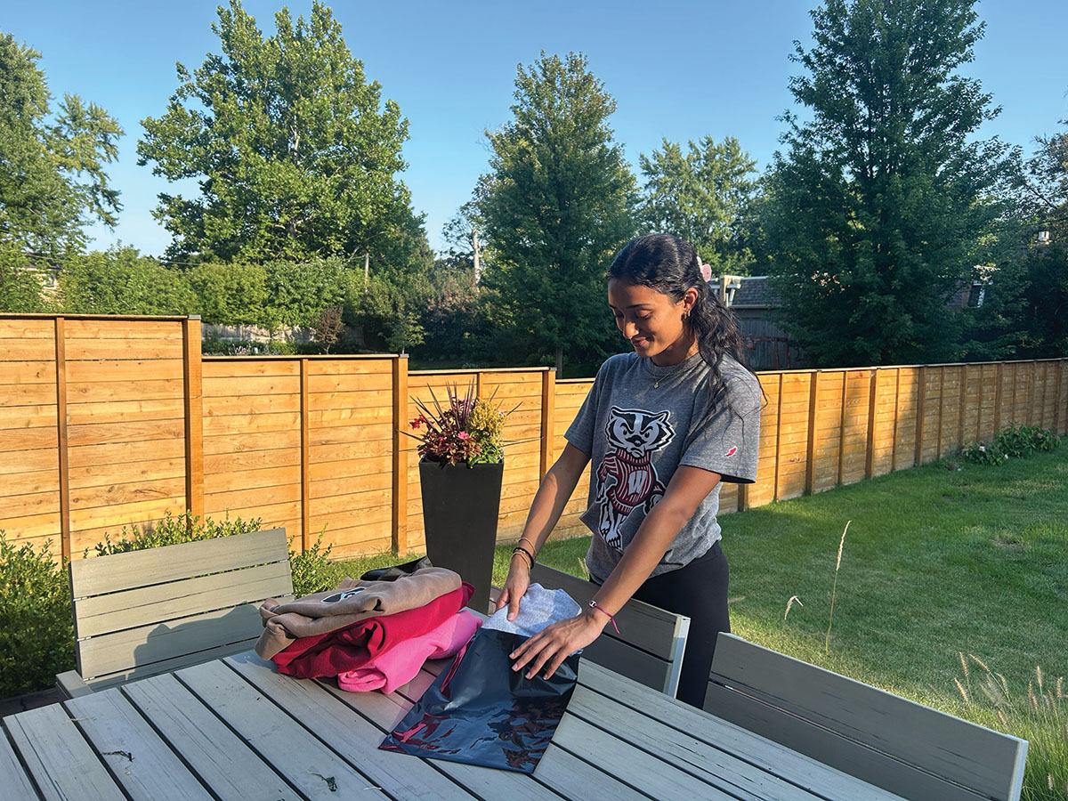 Senior Annika Purohit packages an order for Depop. Basic principles of marketing like product, place, price and promotion apply when selling clothes on resale apps.