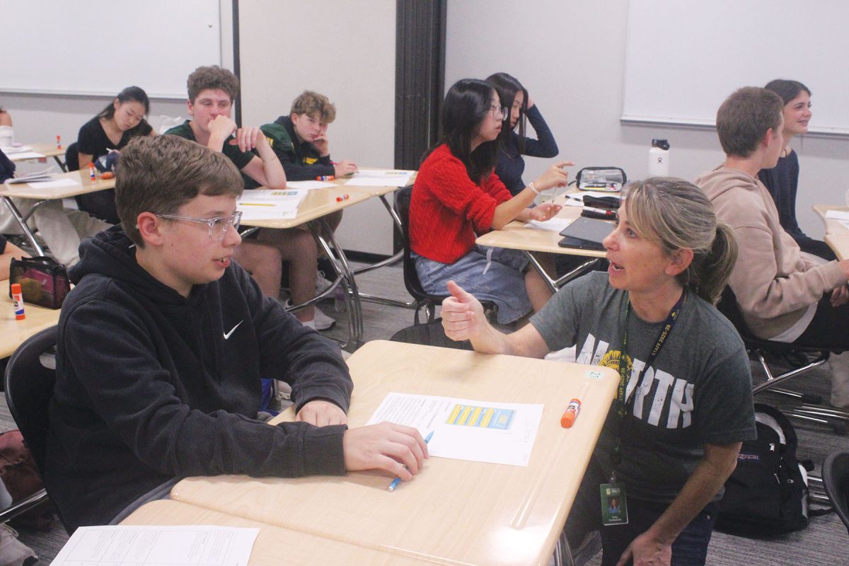 During a Spartan Seminar activity, Amy Goldsmith, multi-tiered systems of supports coordinator (right), speaks with a student. The seminar curriculum was designed to advise on resources, topics and skills necessary to succeed.  