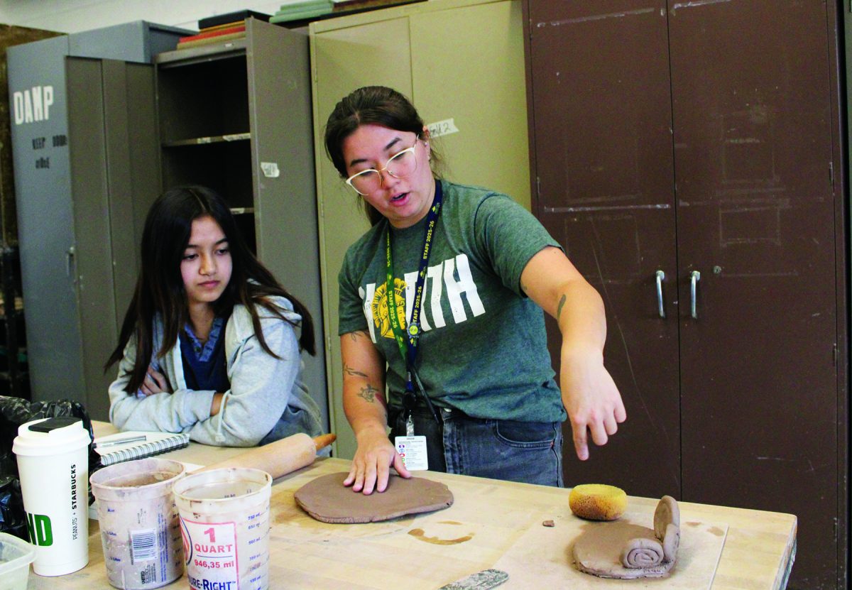 During a Ceramics 1 class, fine arts teacher Keiko Maas (right) helps sophomore Vivienne Gorelov with her coil pot. Maas plans to teach students wheel throwing, a pottery technique for shaping items such as bowls, mugs and vases on a spinning potter’s wheel.