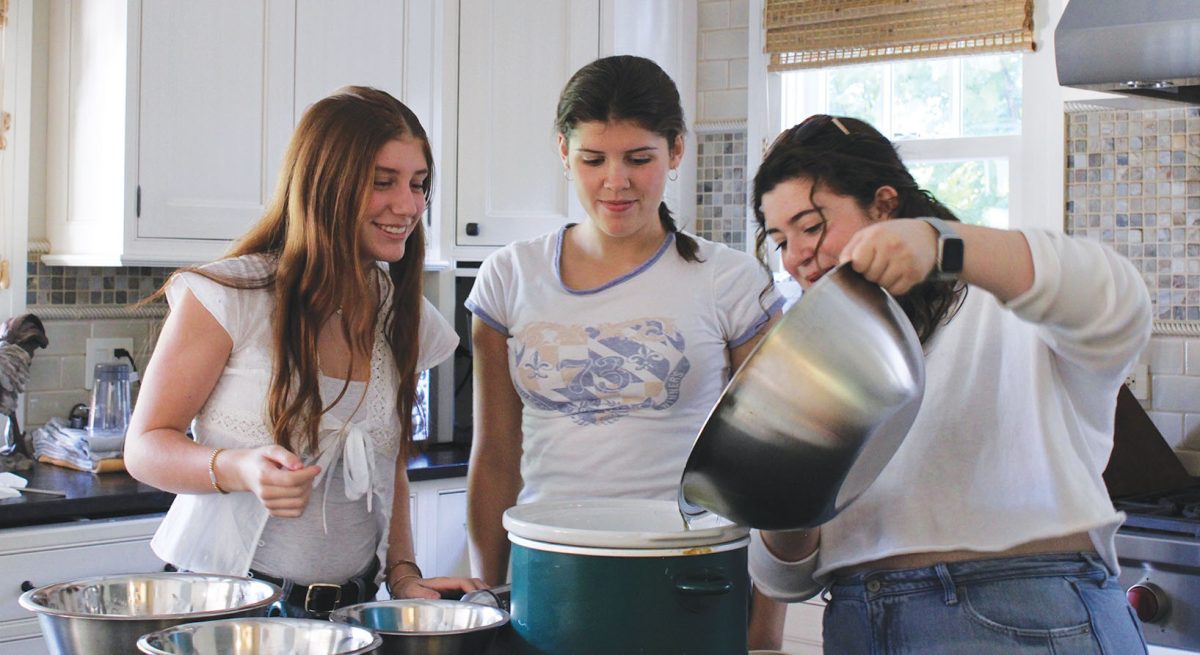 The first batch of one80 Soap’s new holiday bundle is made by seniors Lila Gallinson (left), Mimi Peifer (middle) and Lexi Nortman. The soap is scented using essential oils in collaboration with a Conant High School INCubator team.