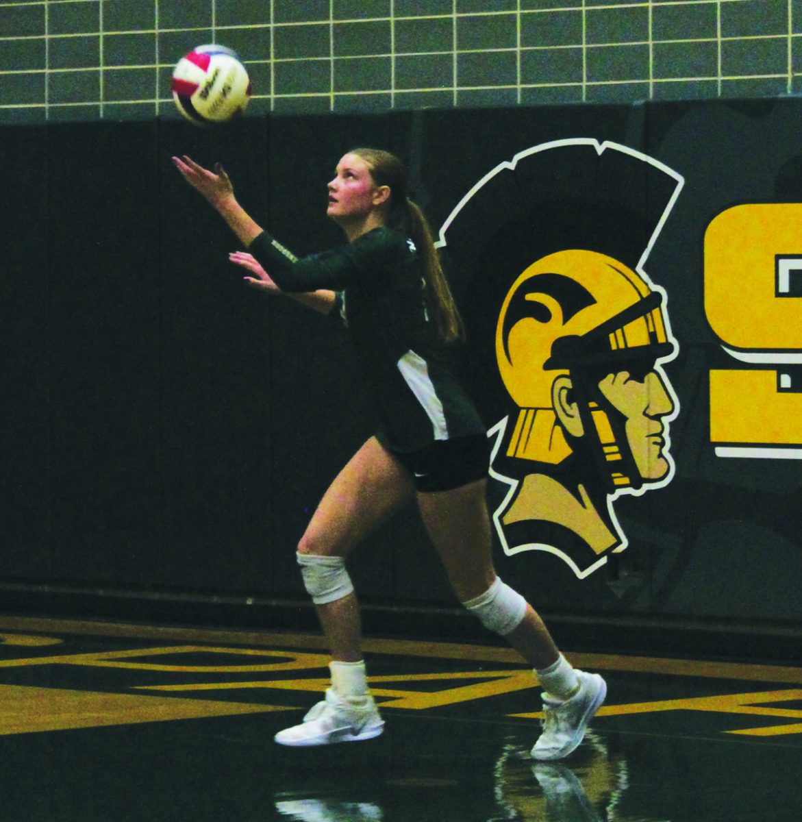 Senior Claire Dillon executes a jump float serve during a conference game against New Trier on Oct. 15, 2025. Before the serve, Dillon performed her ritual of bouncing and spinning the volleyball. 