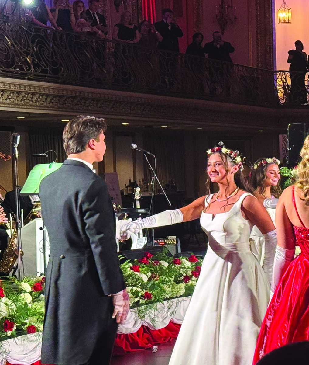 With her escort Parker Incledon, junior Lily Moore dances at the White and Red Ball on Feb. 28. The ball represents a coming of age for high school girls and raises funds for charitable foundations.