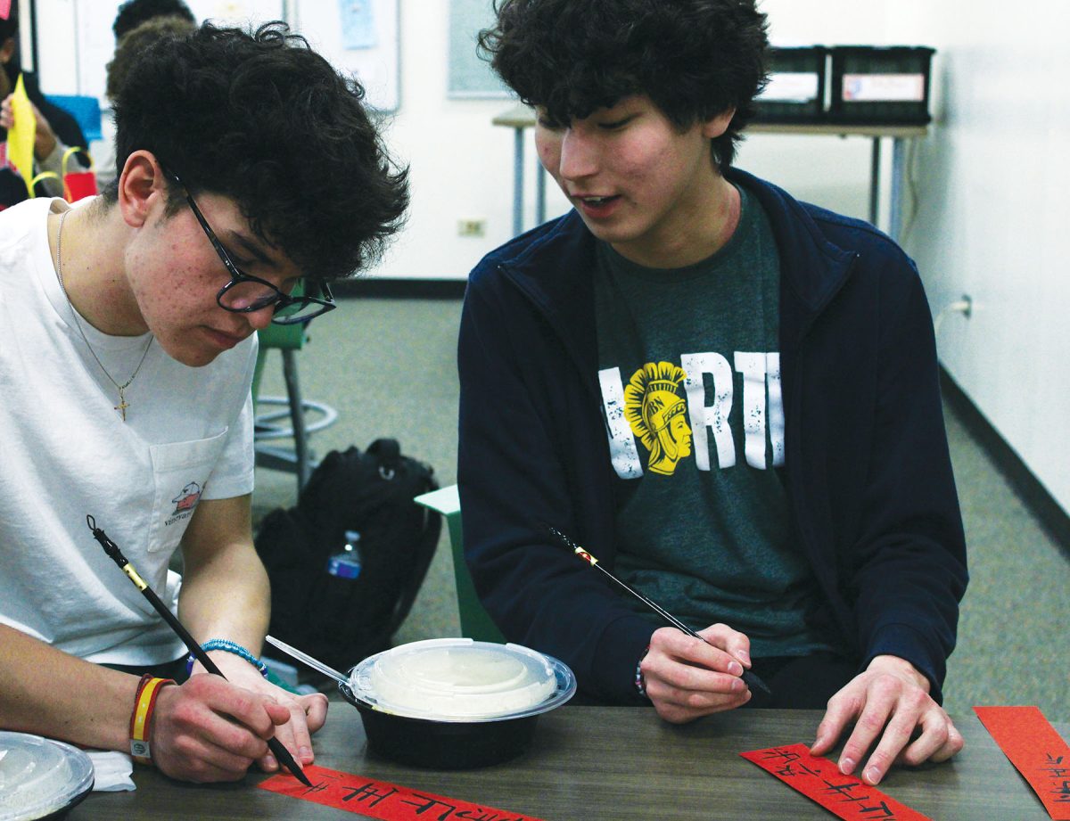 In a World Languages Honor Society Meeting, juniors Michael Entchev (left) and Tushig Munkhbayar practice calligraphy. Out of the 6,000 to 7,000 languages spoken worldwide, 80 percent of the world's speakers use one of 23.
