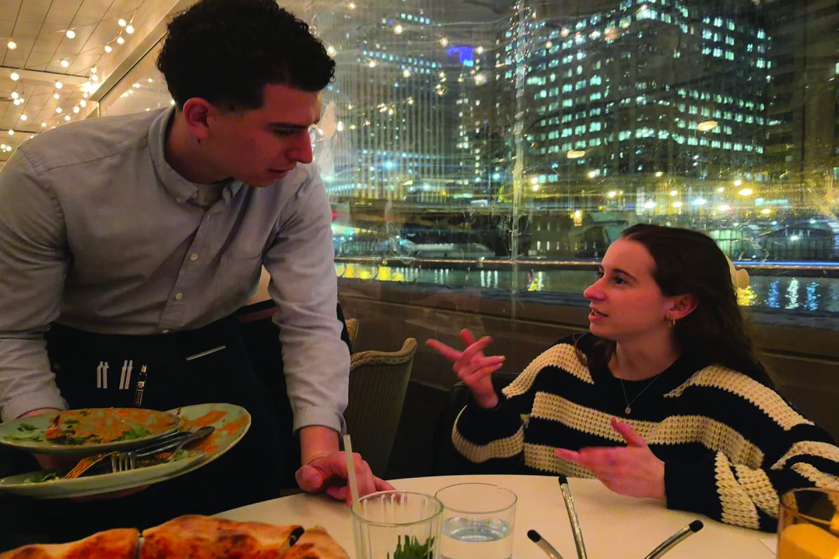 Torch editor Linda Podbielski starts a conversation with her server in Chicago. Podbielski frequently engages in conversations with others to create connections and develop a better understanding of their culture. 