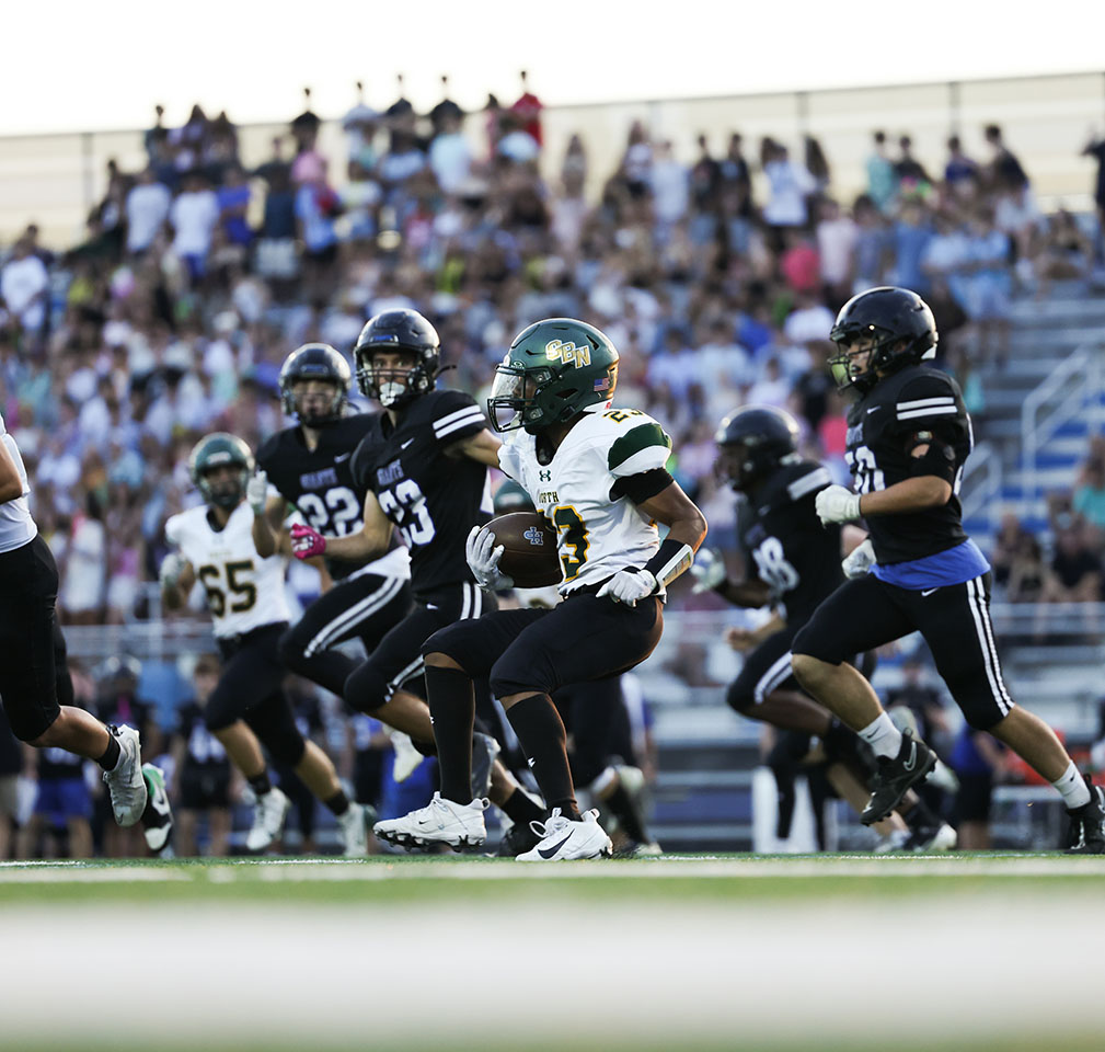 Defense closes in on junior Anthony Sanchez during the Varsity Football game against Highland Park on Sept. 4. Glenbrook North and Highland Park are both members of the new Central Division. Glenbrook North lost to Highland Park 42-7.